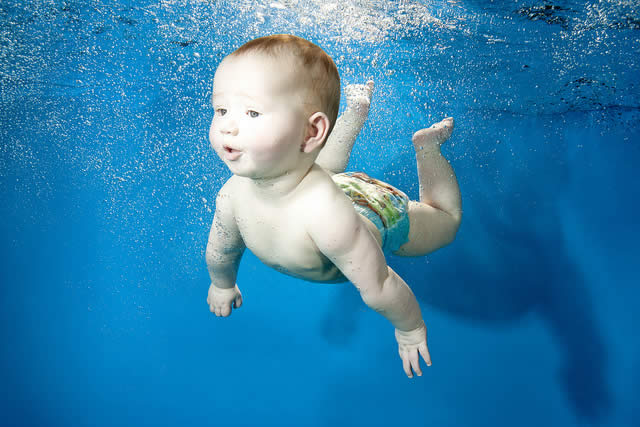 Em bé dễ thương tập học bơi